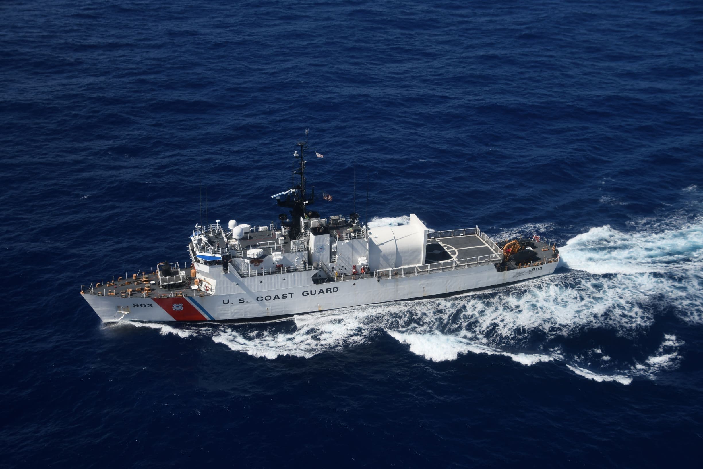 Maritime security personnel monitoring an operational situation at sea.
